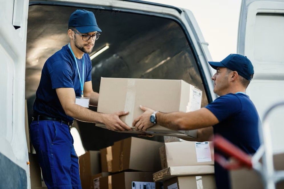delivery-men-loading-carboard-boxes-van-while-getting-ready-shipment