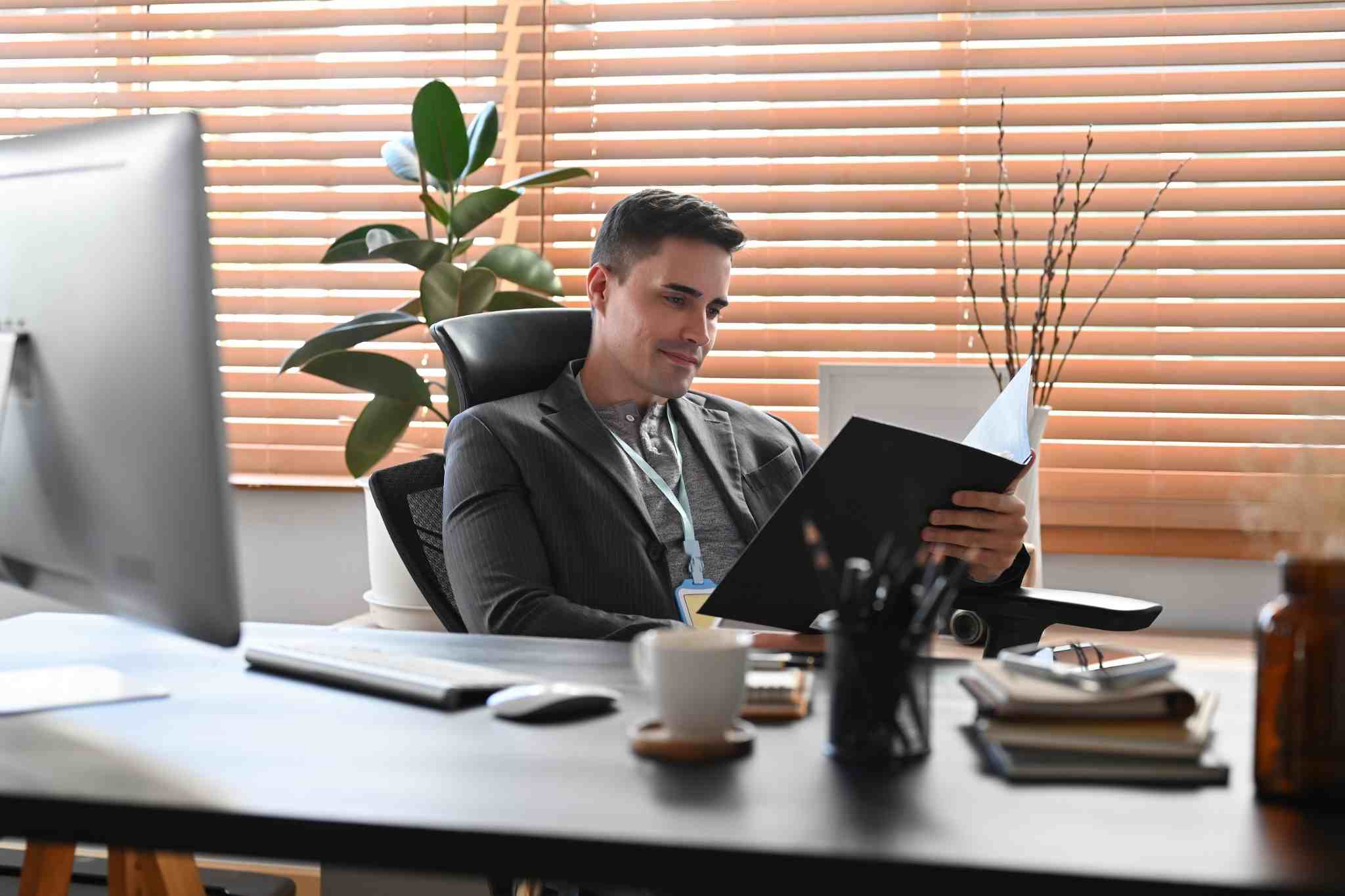 Men sitting in his office chair