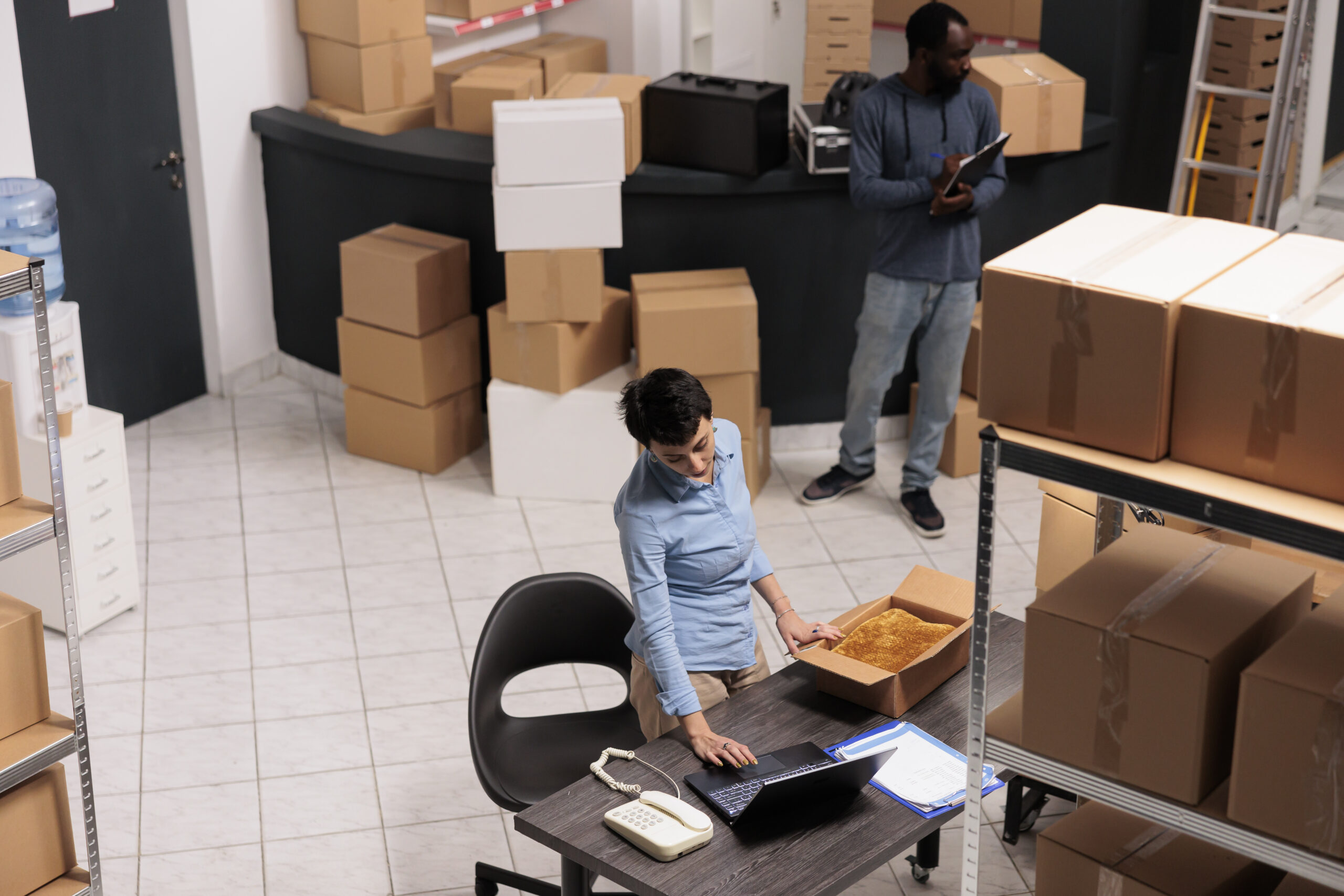 A female warehouse manager checking a package.