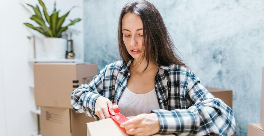 Woman Packing Moving Boxes