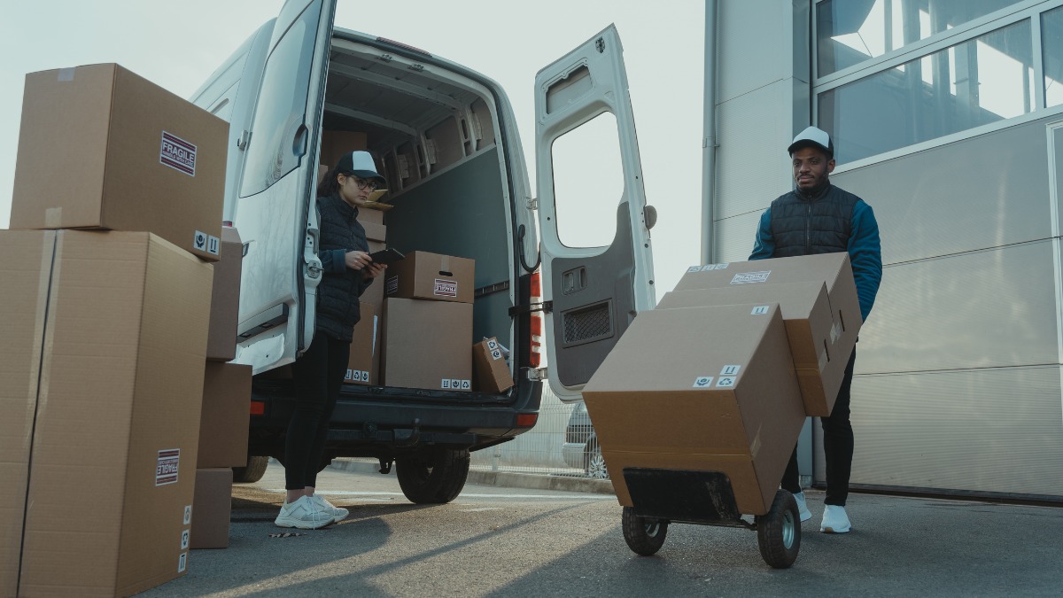 Delivery workers loading cardboard boxes